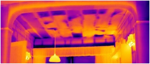 Thermal image of flat roof with damaged and deteriorating insulation