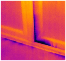 Thermal image of air leakage at bottom of external door
