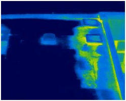 Thermal image of water leak on flat roof shown as lighter colours